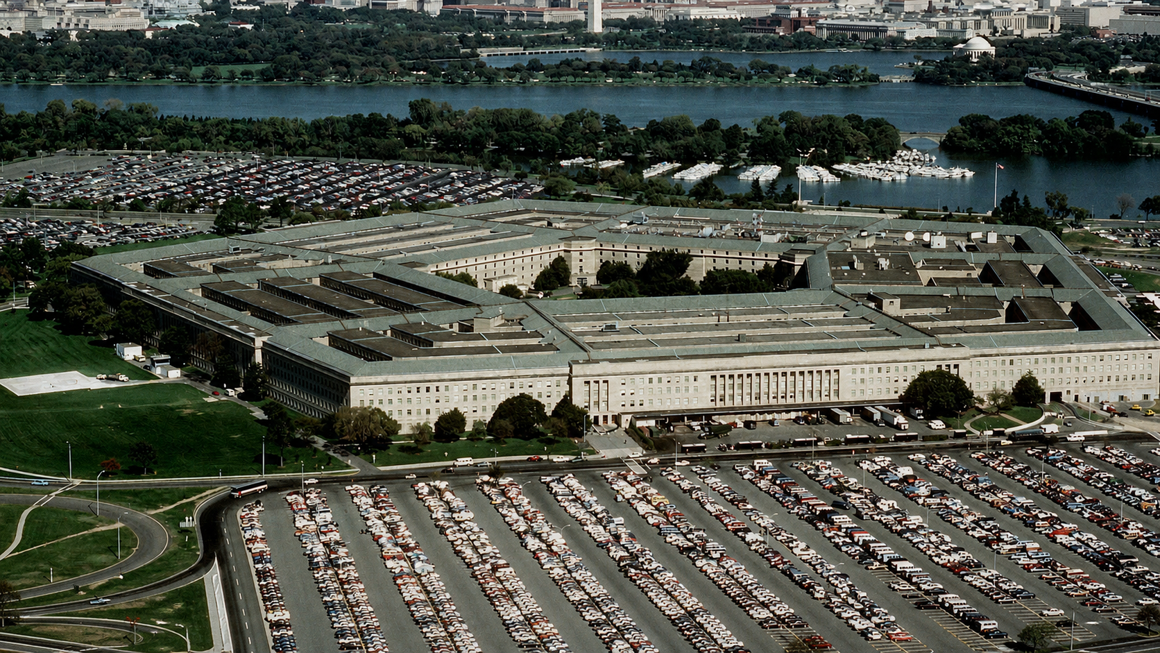 Aerial view of the Pentagon complex with the Potomac River and parking areas beyond.