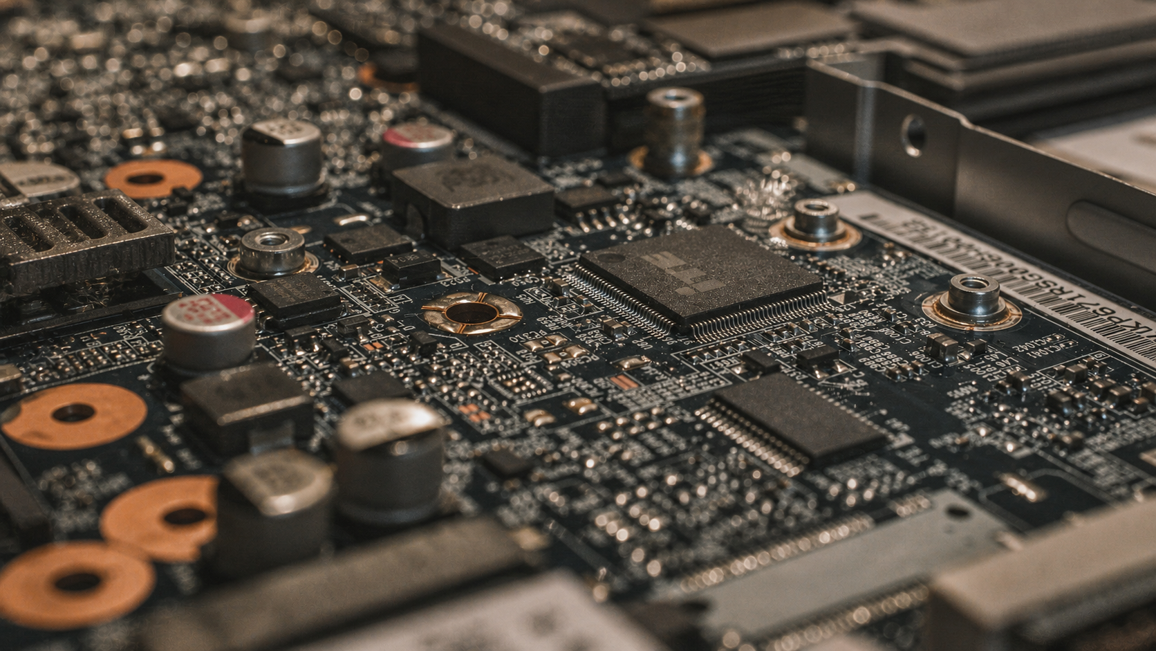Wide macro view of components, fasteners, and traces on a circuit board.