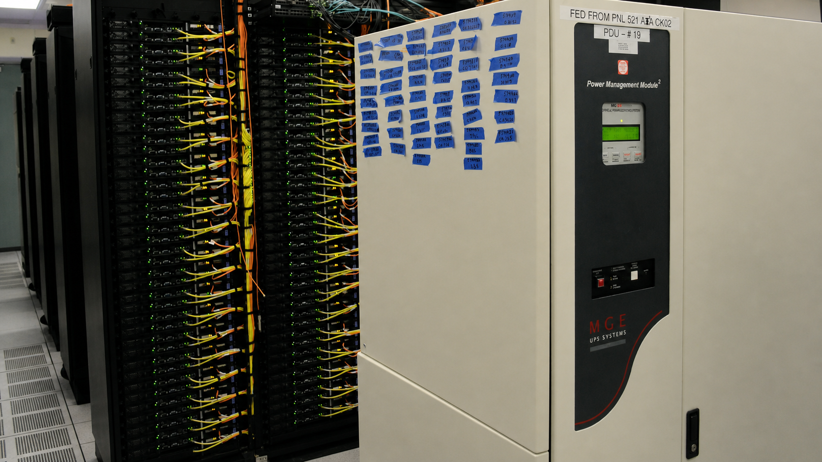 Power-management cabinet beside cabled computing racks in the NERSC data center.