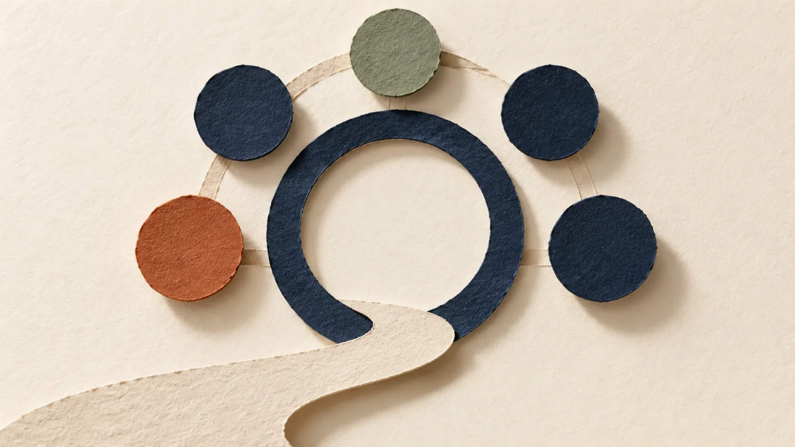 Five colored paper circles arranged around an open navy ring on ivory paper.
